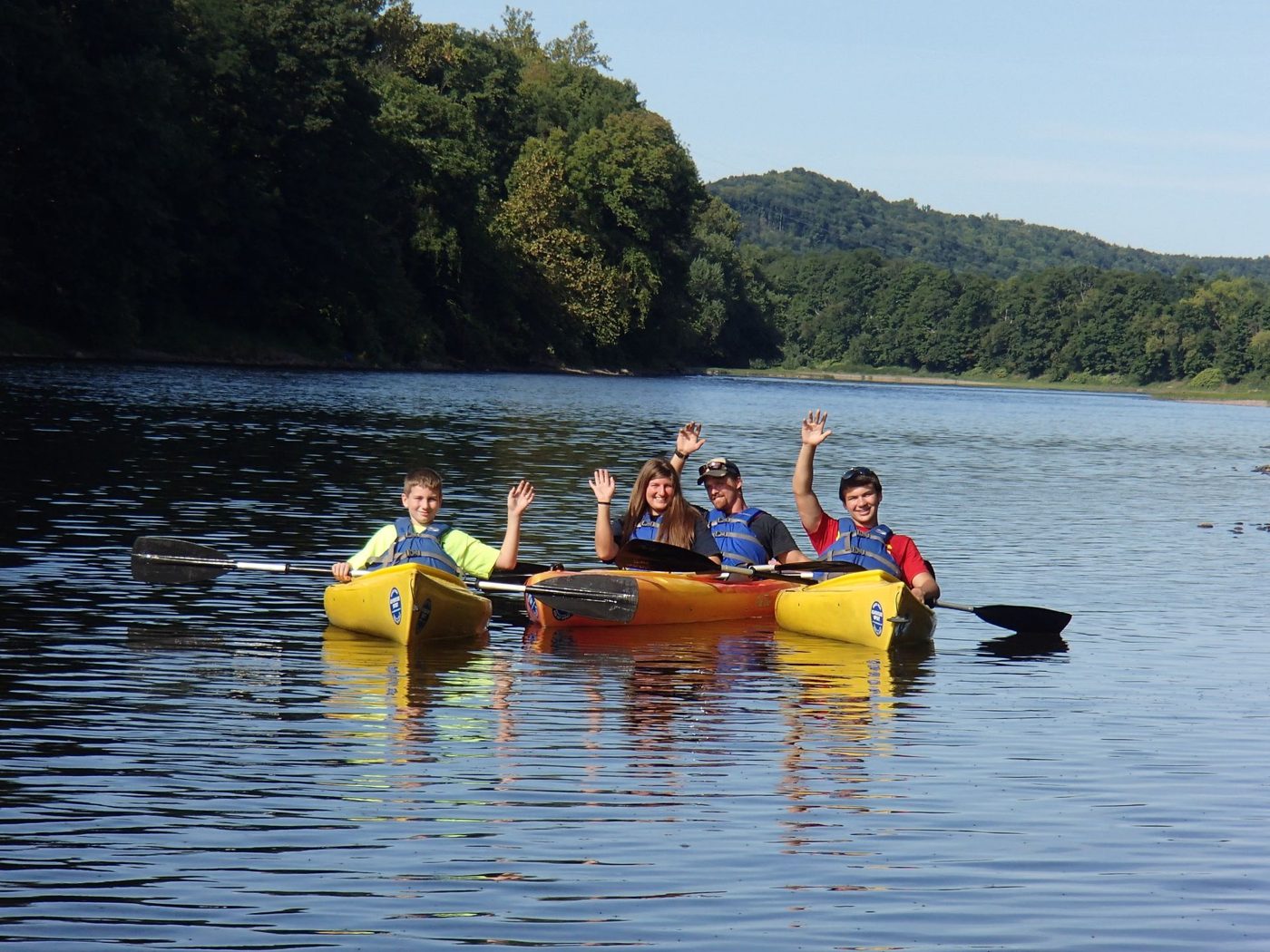 Friends paddling kayaks on the Delaware River